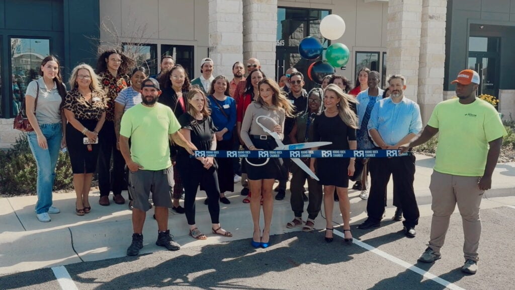 Residences of Siena South team and representatives of the Round Rock Chamber of Commerce cutting ribbon at the grand opening celebration 
